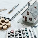 House model with real estate agent and customer discussing for c House model with real estate agent and customer discussing for contract to buy house, insurance or loan real estate background.
