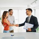 couple man deal woman contract business agent agreement estate i Real estate agent with couple shaking hands closing a deal